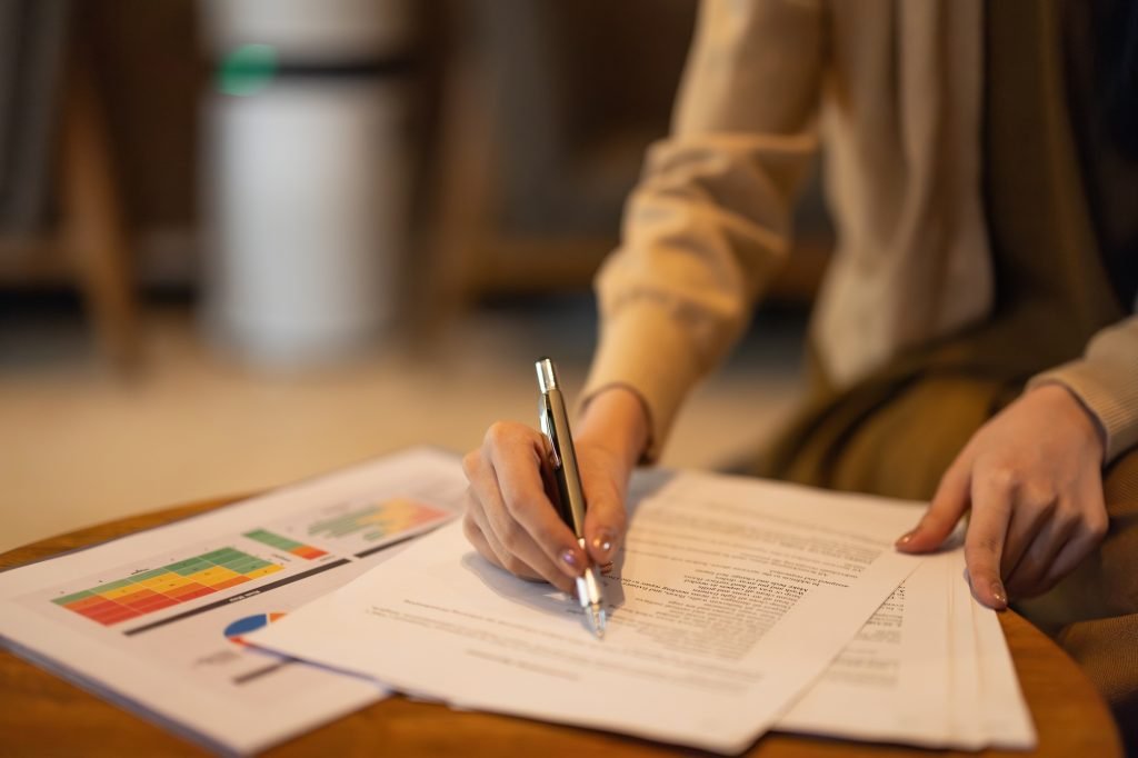 Asian woman executive thoroughly analyzes, remotely approves investment for strategic company growth